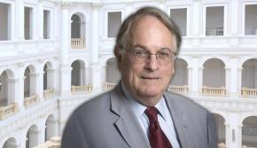 Photo of Prof. M. Stanley Whittingham on the background of the Main Hall in the WUT Main Building